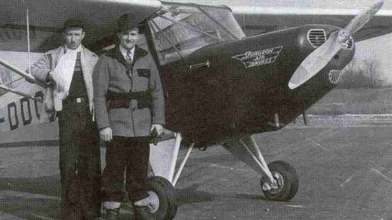 Pioneer aviator James Sturgeon, on the right, and flying instructor Norman Carruthers are standing in front of a CF-DDQ Fleet 80 Canuck at the Barker's Point Airfield.