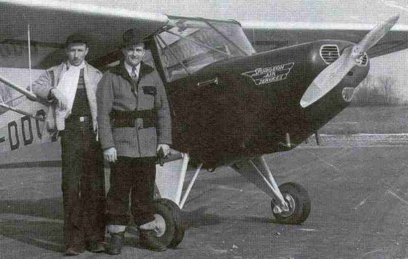Pioneer aviator James Sturgeon, on the right, and flying instructor Norman Carruthers are standing in front of a CF-DDQ Fleet 80 Canuck at the Barker's Point Airfield.